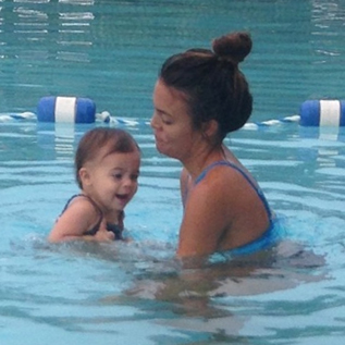 Melissa Swanson in a swimming lesson at home with an infant.